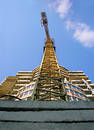 Tall orange crane constructing a new business building