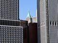 Smaller building between two skyscrapers in lower Manhattan, New York City, USA