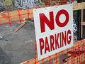 No Parking sign in a neighborhood with graffiti