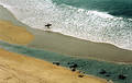 Lone surfer approaches the sea