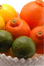 Three citrus in white bowl