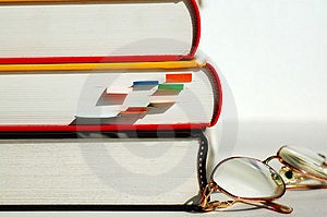 Tři knihy a brýle.
