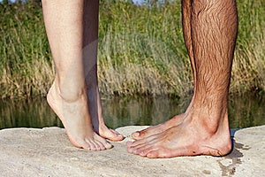couple feet kissing near lake couple feet kissing near lake