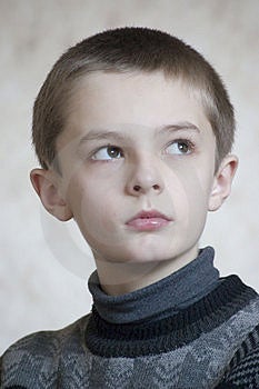 Ragazzo serio ritratto su sfondo chiaro.