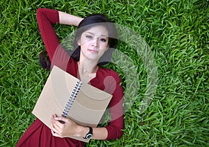 Woman lying on grass with book Stock Photo Woman lying on grass with book Stock Photo