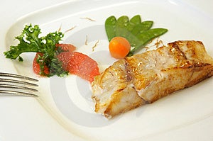 Una fetta di salmone alla griglia con verdure.