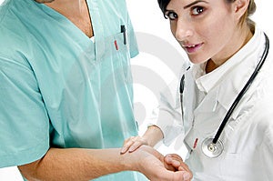 Young Nurse Checking Pulse Of Patient Free Stock Photo