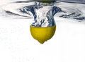 Lemon dropped into water free stock image